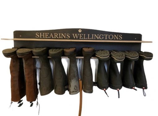 Wooden 5 Pair wall hanging welly Rack engraved with a family Name showing wellies hanging.