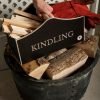 Kindling box on a log storage container with red fire gloves