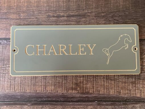 grey smooth wooden name sign with a jumping horse