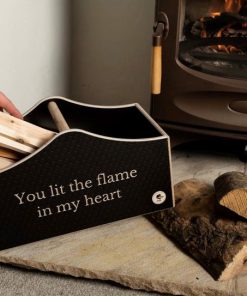 Kindling box next to the fireplace with hand taking out sticks