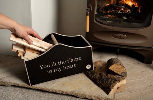 Kindling box next to the fireplace with hand taking out sticks