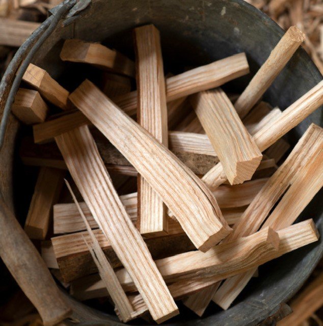 Metal bucket for a fireplace accessory is not an attractive firewood storage solution. 