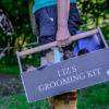grooming kit with horse in the background