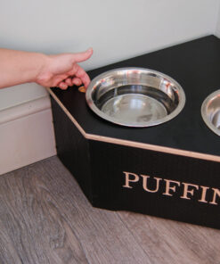 medium corner dog bowl stand with someone removing the bowls using the finger recess.
