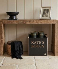 Wooden boot box that is personalised with Kate's boot, under a hall table
