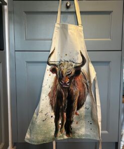 highland cow apron hung on a cupboard door